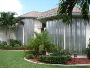 Gray hurricane panels on windows of house