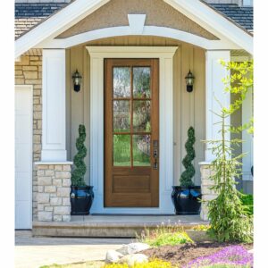 Well kept greenery in front of house with a glass and wood door